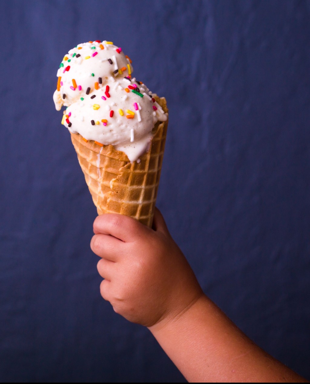 child-holding-ice-cream-cone